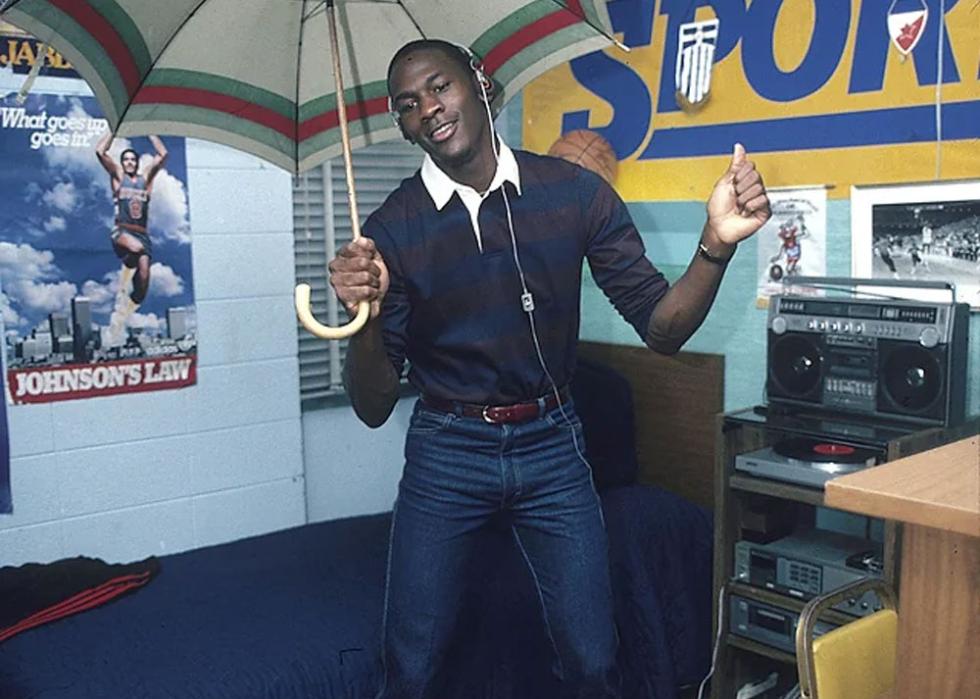 Michael Jordan holding an umbrella dancing in his dorm room