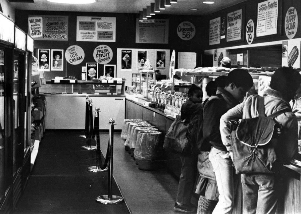 Black and white photos of kids in line at a deli in Chicago