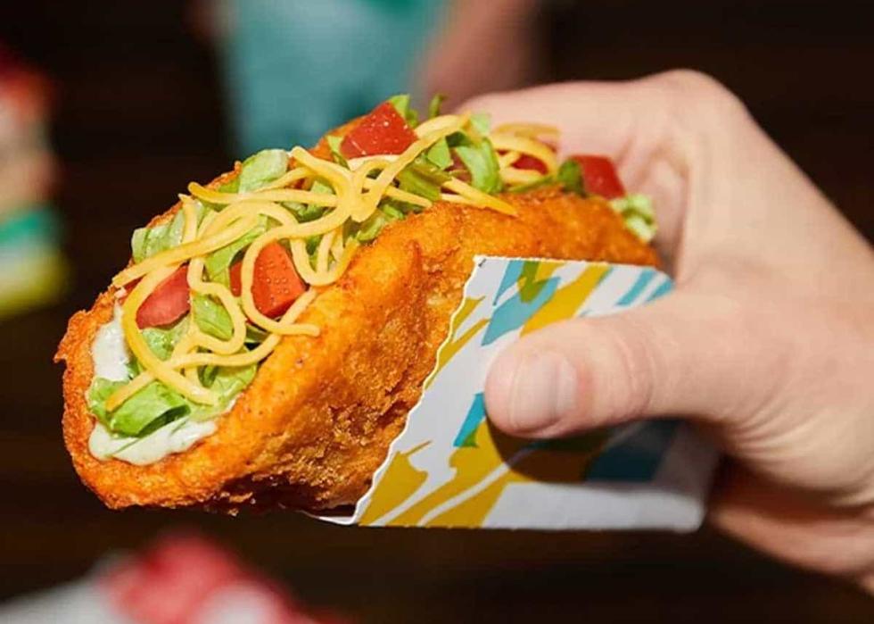 A hand holding a naked chicken chalupa