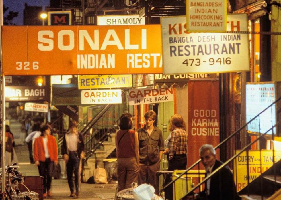 Some people sitting around on 6th street in NYC