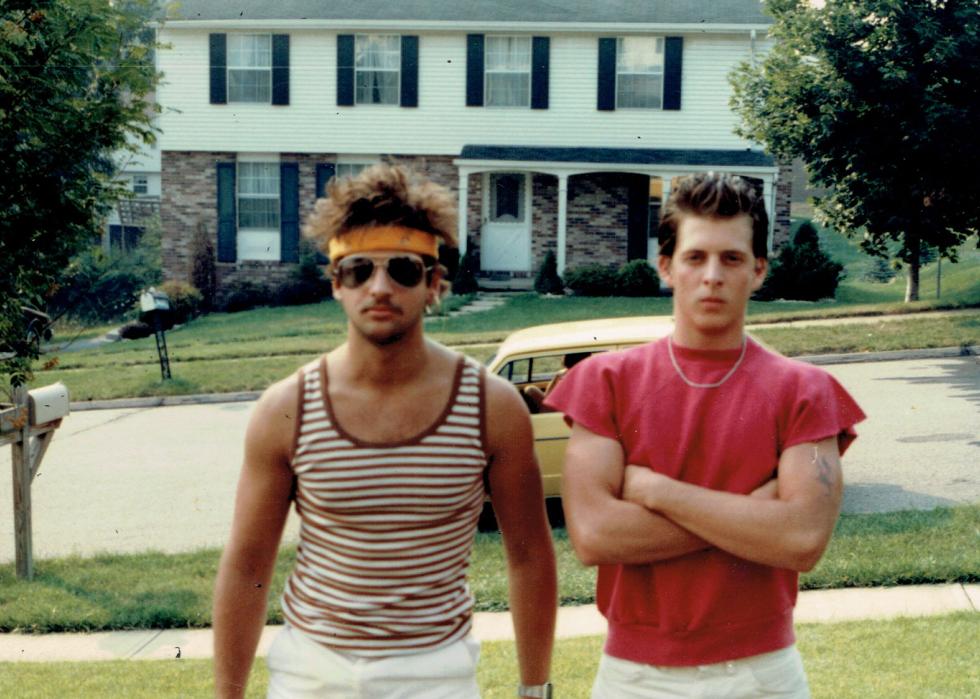 Two guys standing in a front yard dressed for a concert