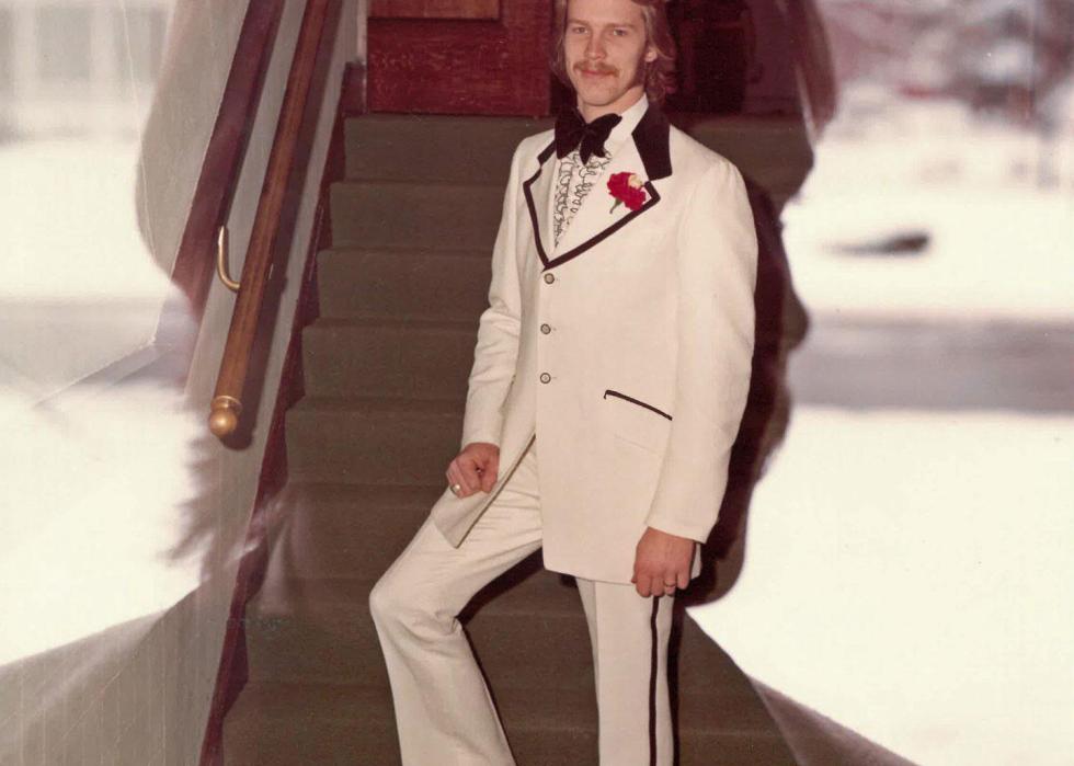 A man standing for a portrait on his wedding day