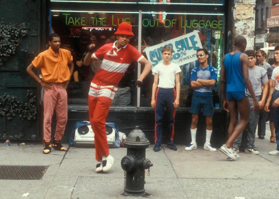 Photo of multiple young men hanging out on the street dancing