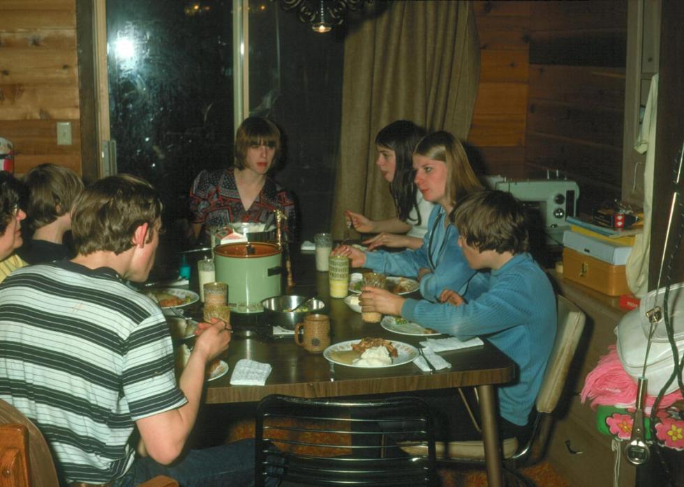 A family sitting around a dinner table eating