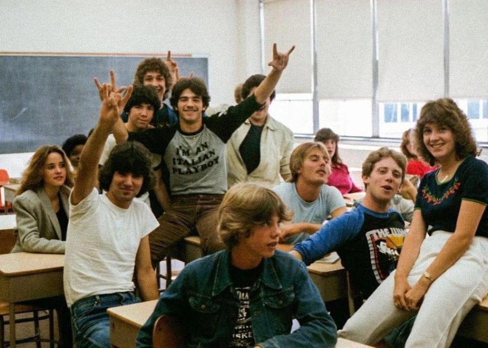 Kids sitting around in a classroom posing for the camera