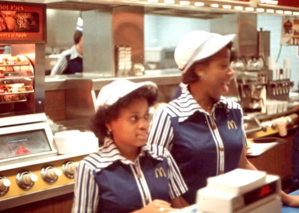 Two woman behind the register at a McDonald's in the 1980s