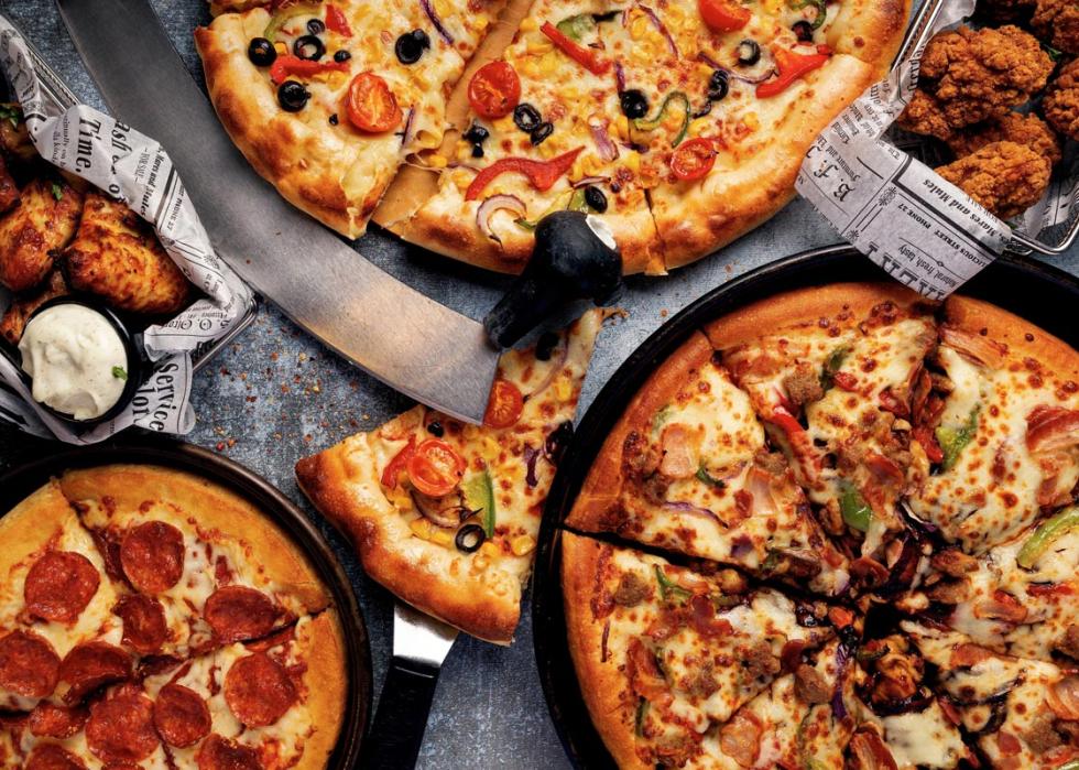 Overhead shot of Pizza Hut pizzas and chicken wings