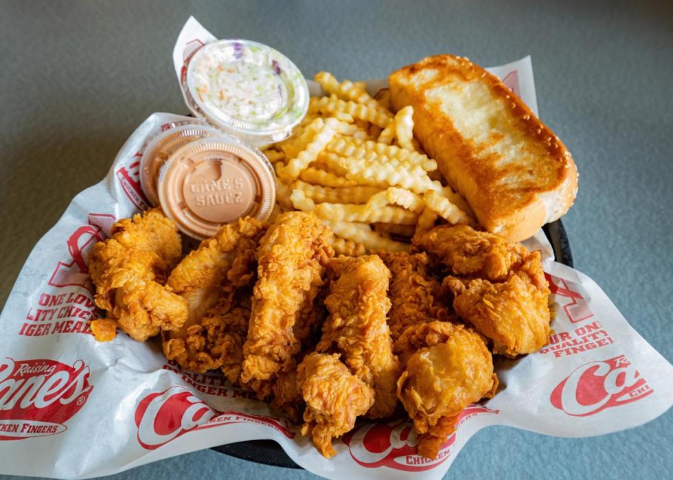 Close up shot of a basket of chicken and french fries from Raising Cane's