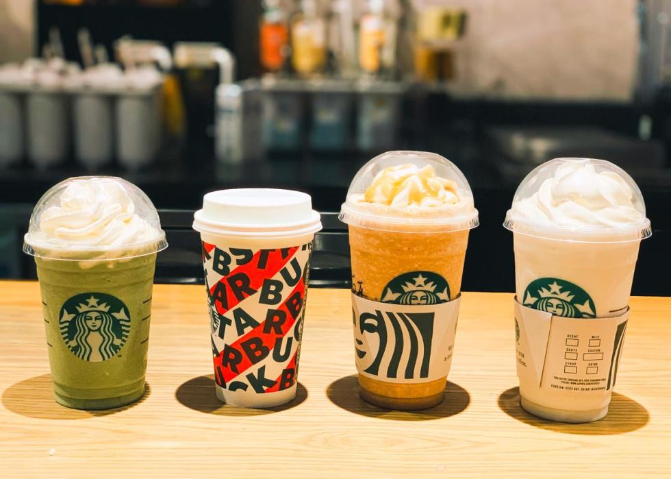 Green tea cream Frappuccino, hot coffee, vanilla cream Frappuccino and mango Frappuccino at a Starbucks