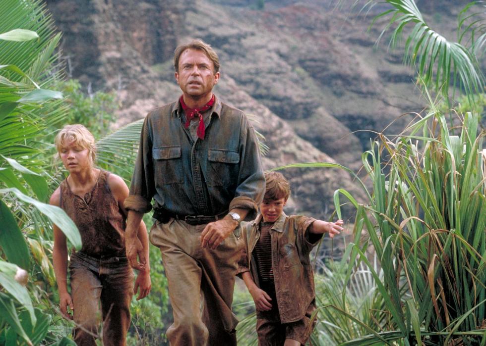 Actor Sam Neill as Dr. Alan Grant, with Ariana Richards (left) and Joseph Mazzello (right) as Lex and Tim, in a scene from the film 'Jurassic Park', 1993.