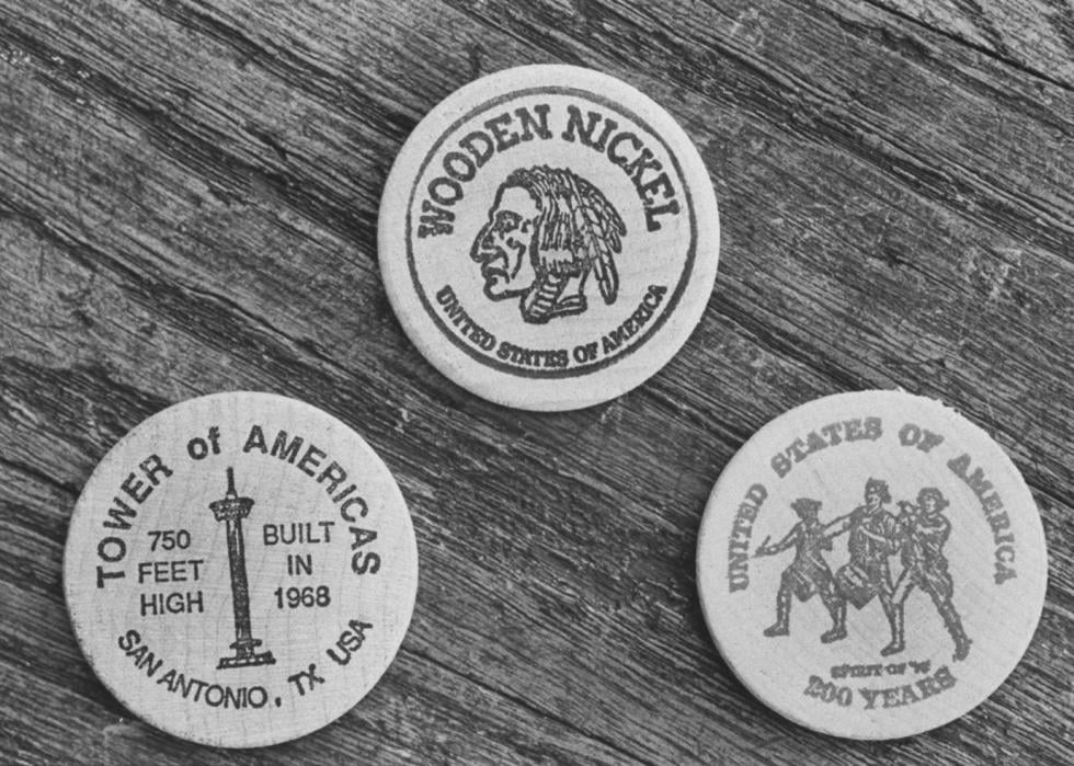 Closeup of 3 maple-cured wooden nickels showing off flip sides