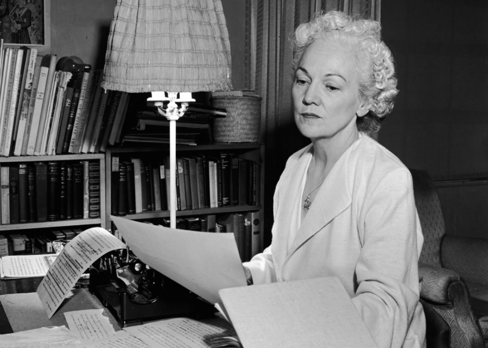 Katherine Anne Porter at desk with typewriter