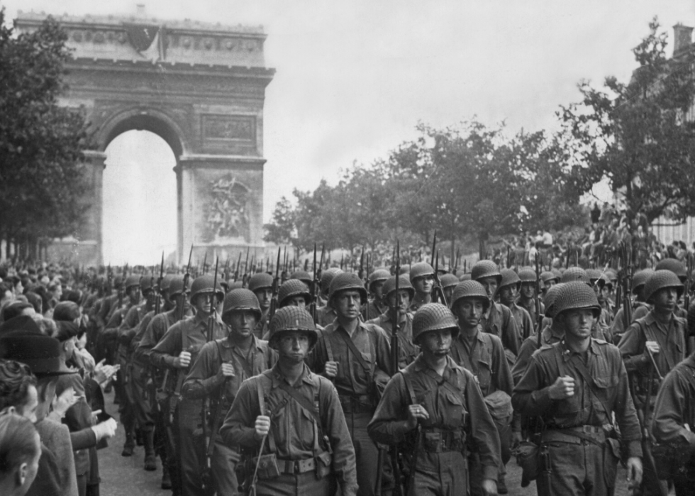 American troops parade through the Arc de Triomphe during the liberation of Paris on Aug. 25, 1944.