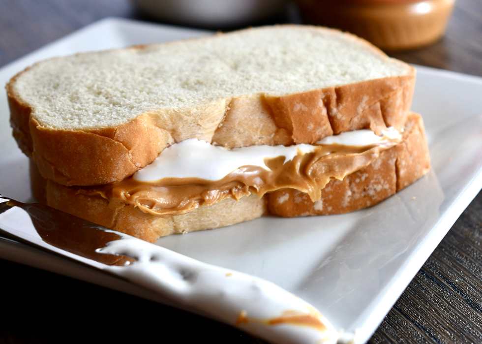 Fluffernutter sandwich on a white plate.