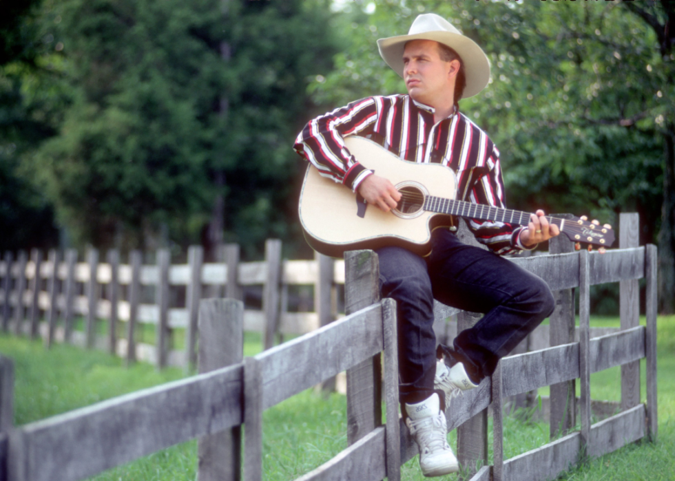 Garth Brooks poses for a portrait on a fence.