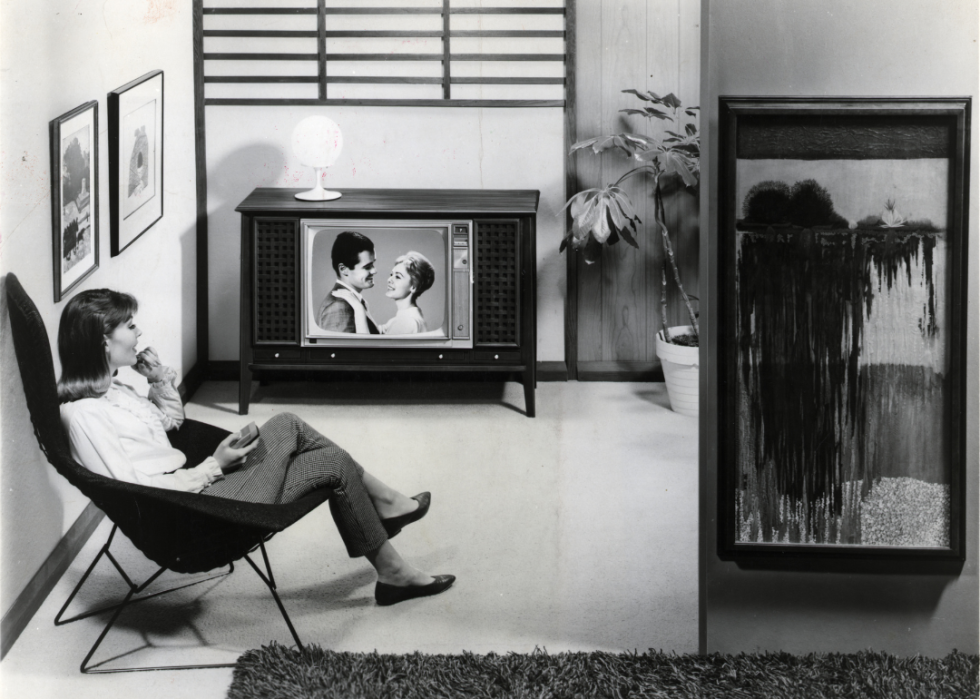 Woman watches television show.