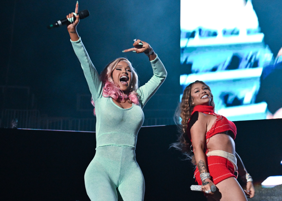 Cardi B and Latto perform onstage.
