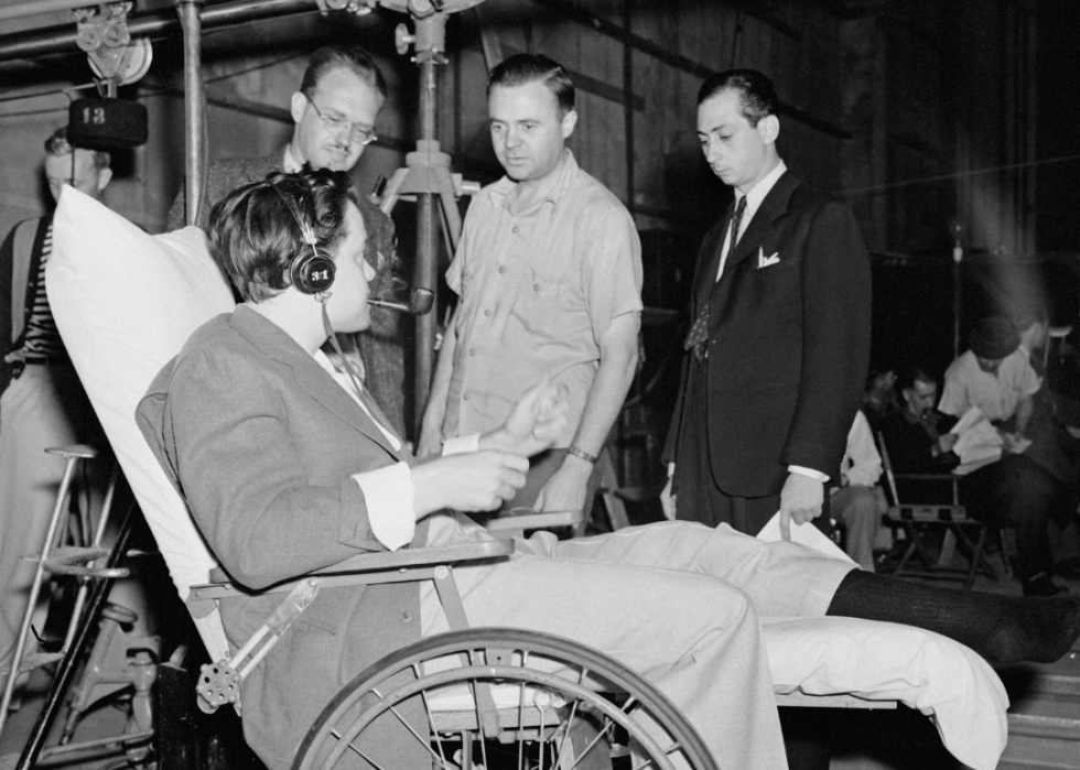 Orson Welles in wheelchair on the set of ‘Citizen Kane’.