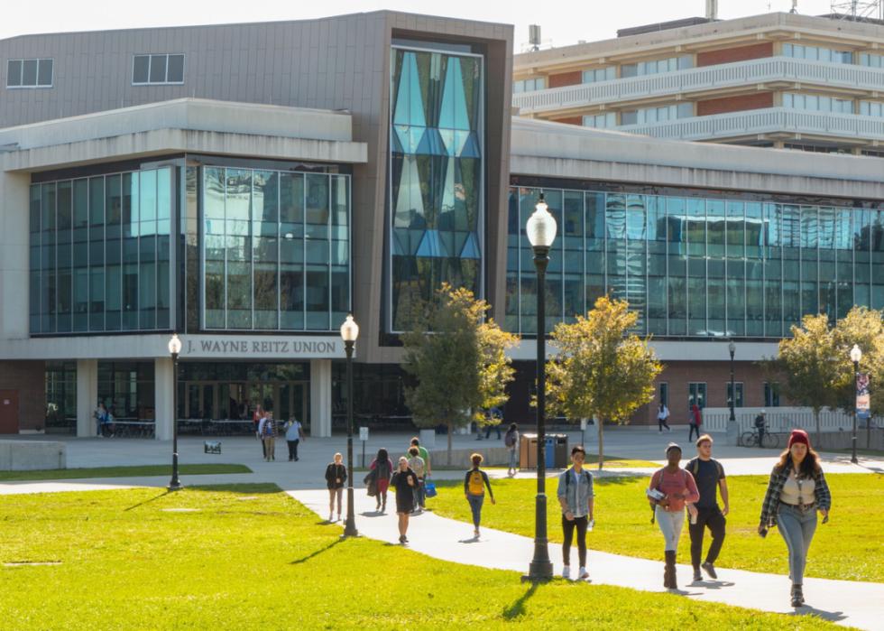 Students walk outside on the Quad lawn.