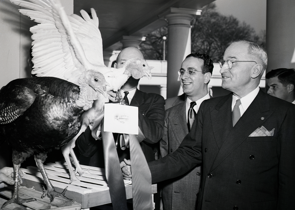 President Harry Truman poses with Christmas turkeys.