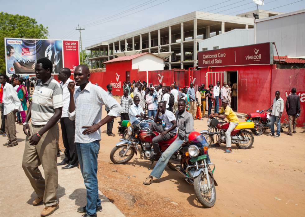 Men gathered in the streets with motorcycles in Juba