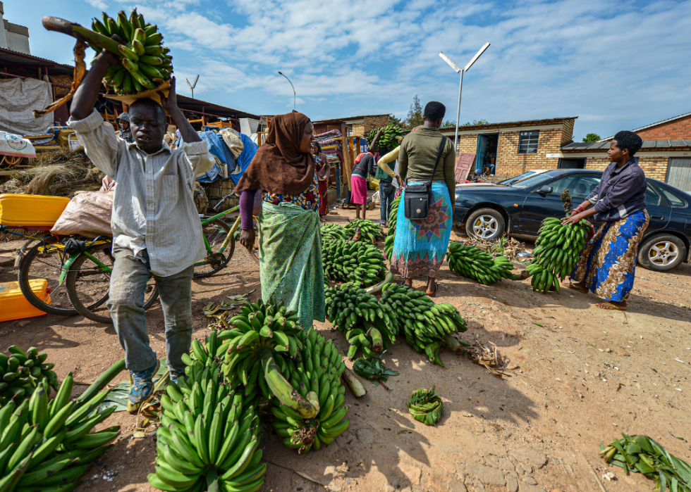 People selling bananas at a street market in Huye