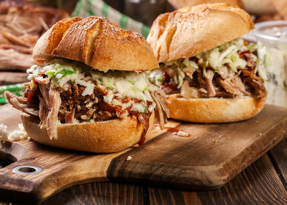 Homemade pulled pork burger with coleslaw salad and barbecue sauce.