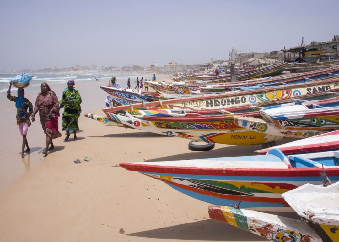 Women beside fishing boats on the beaches of Yoff