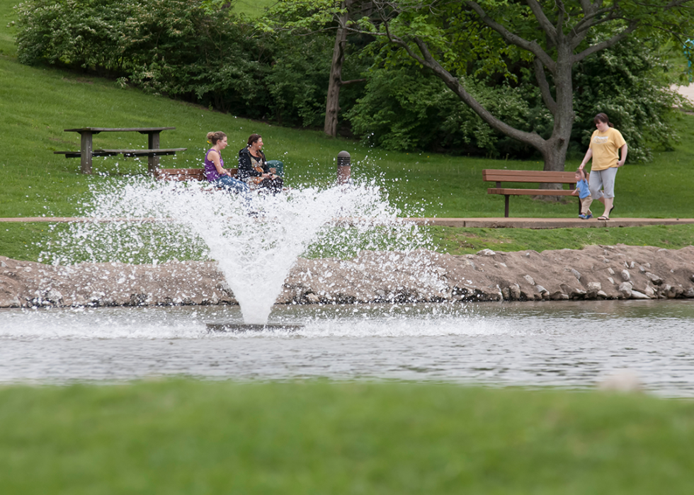 Family and children walking in park.