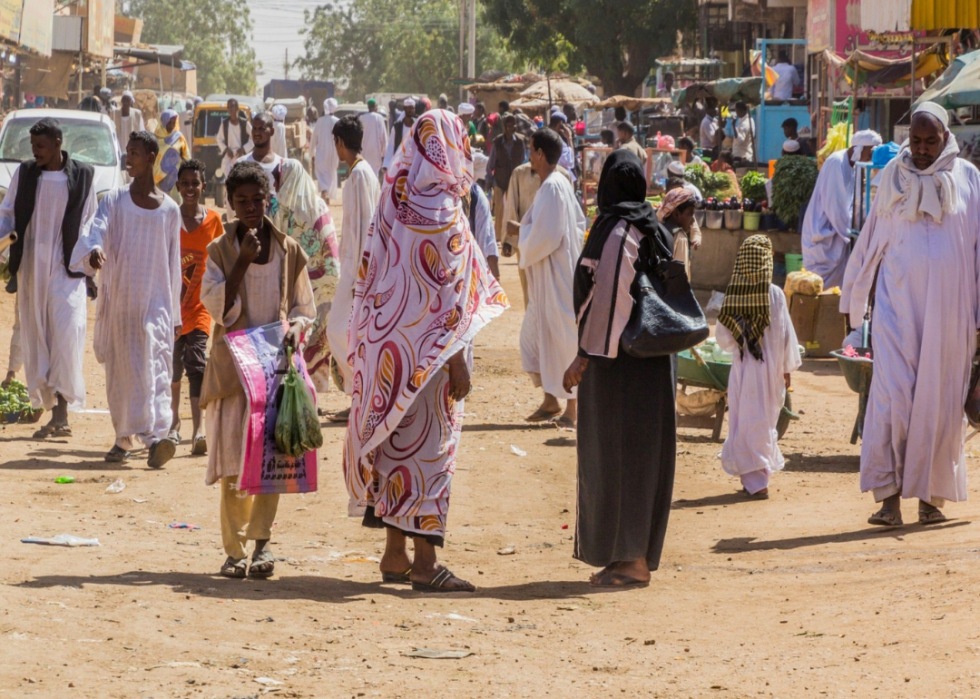 Many people on a dirt street in Shendi