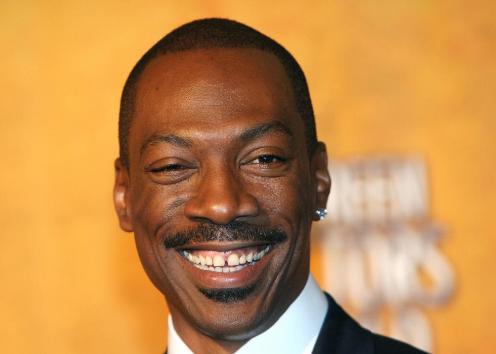 Eddie Murphy smiles at event.