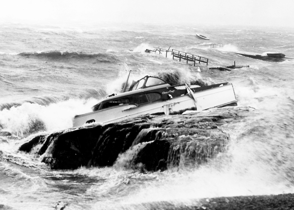 Strong waves hit a speedboat crashed against the rocks.