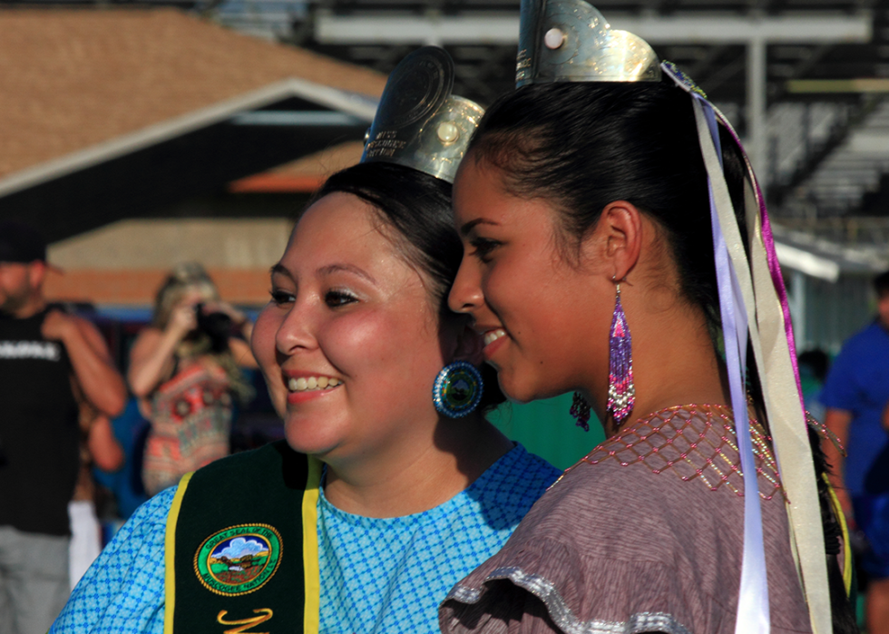 Two women pose for portraits at a traditional Muskogee Creek nation stomp dance in Okmulgee, Oklahoma.