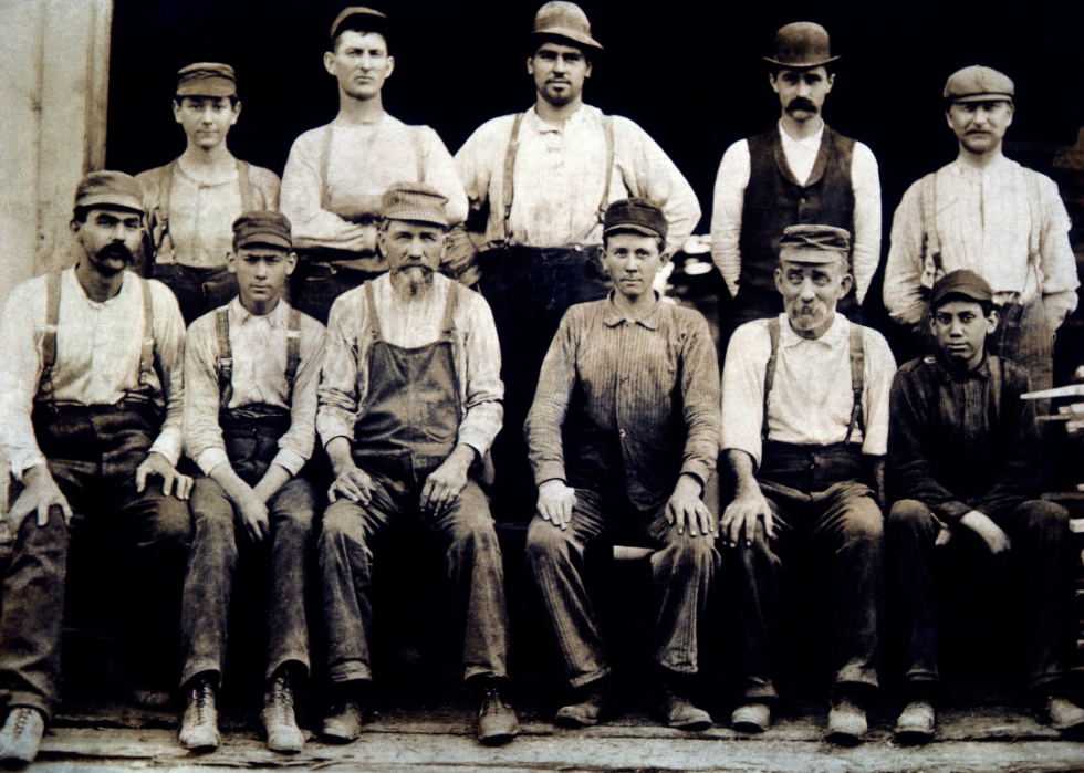 Group of workmen seated and standing