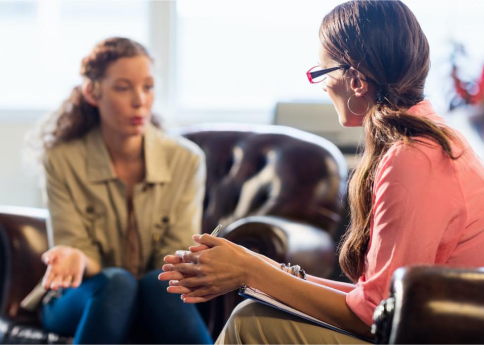 Therapist listens to a patient in her office.