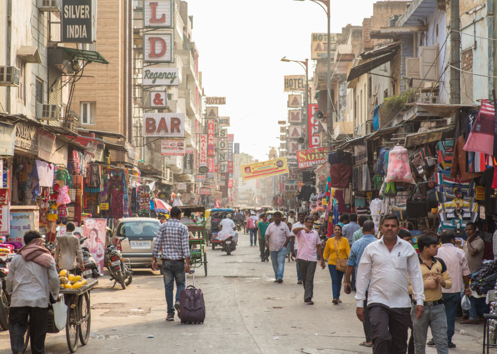 People walking down a crowded street in New Delhi