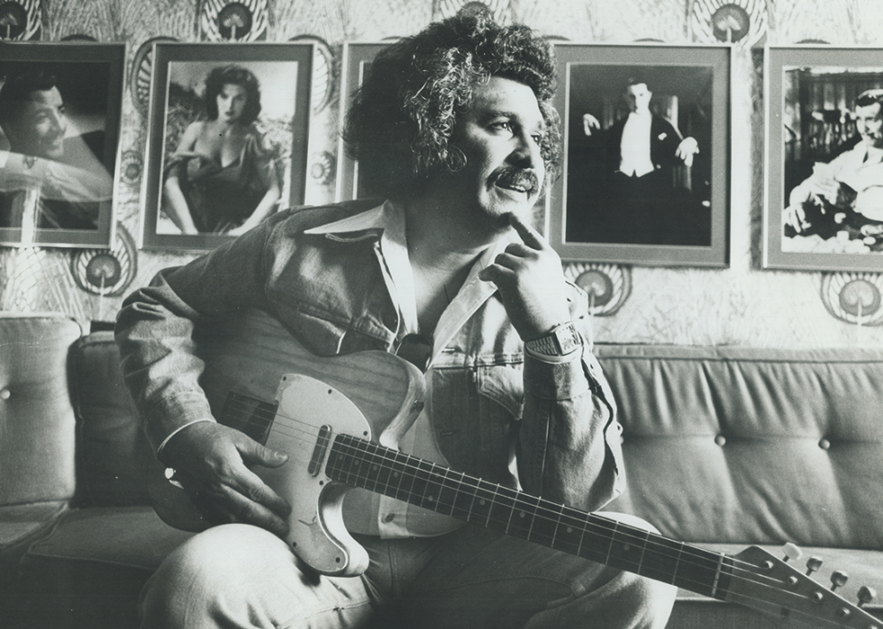 Freddy Fender poses for a portrait with guitar.