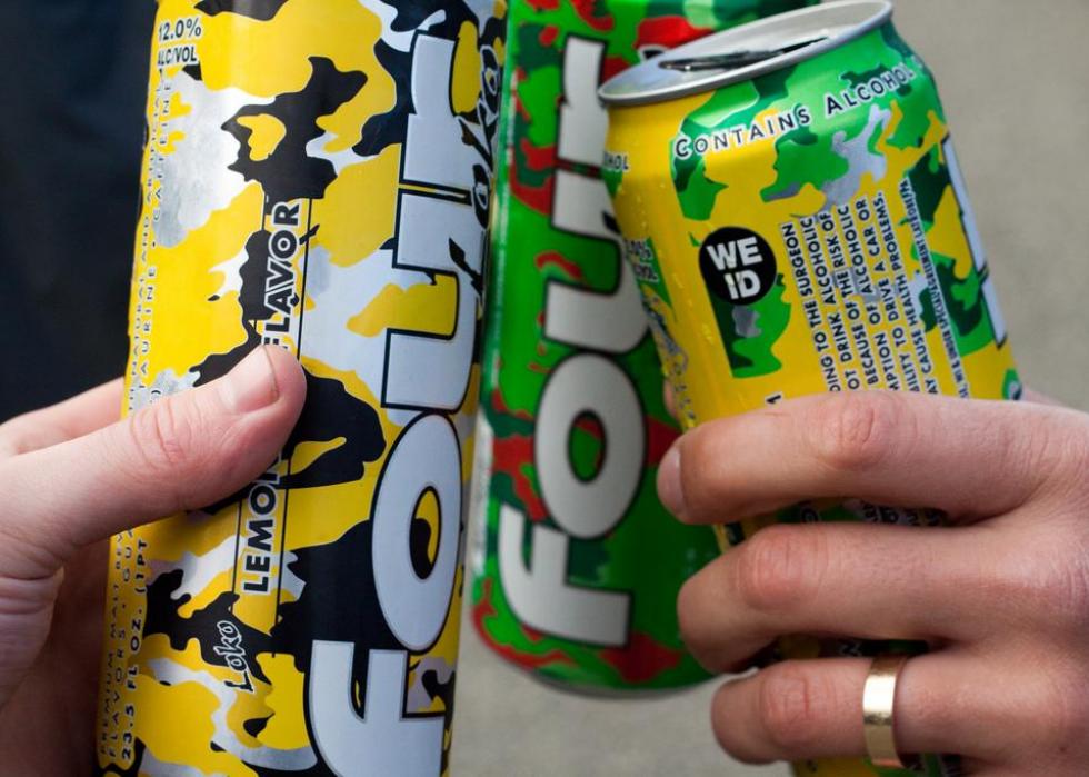 People clinking Four Loko cans together.