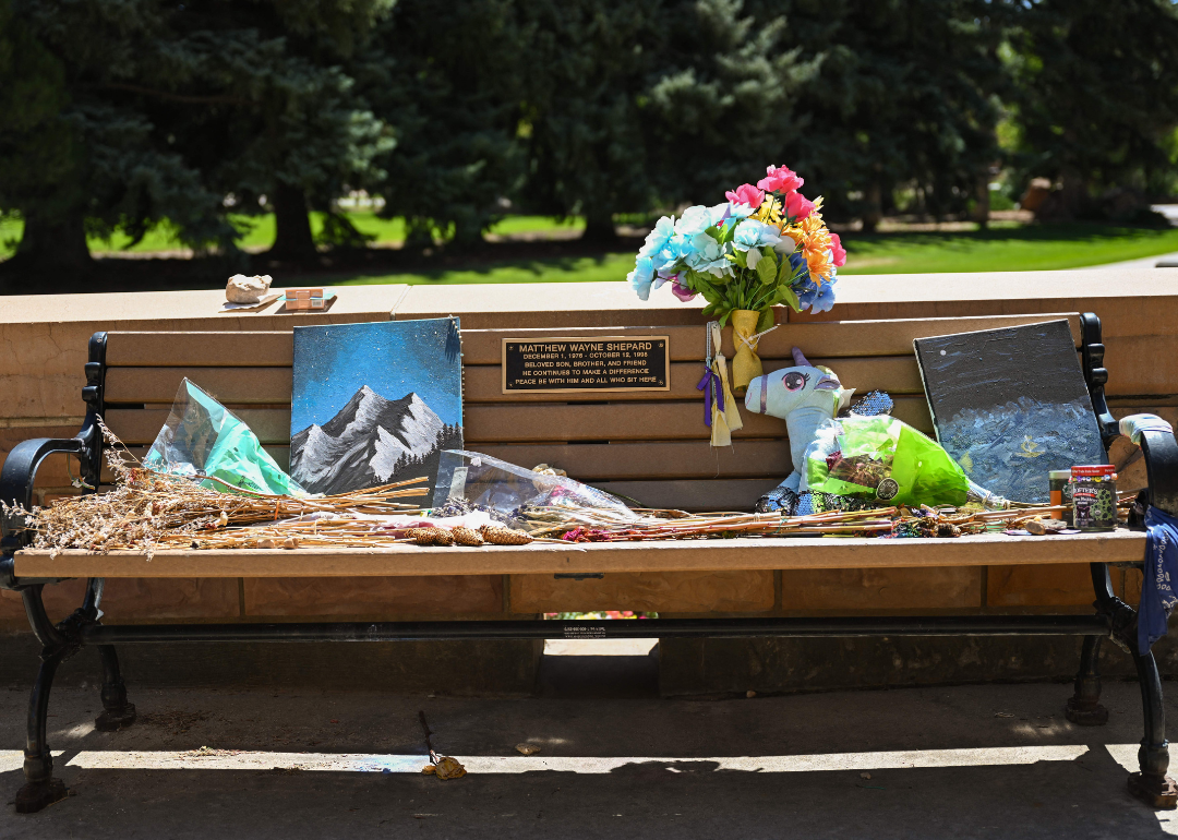 Flowers rest on the Matthew Shepard Memorial Bench