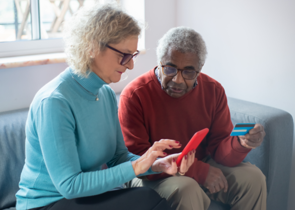 An older couple suscribe to mailing lists on a tablet