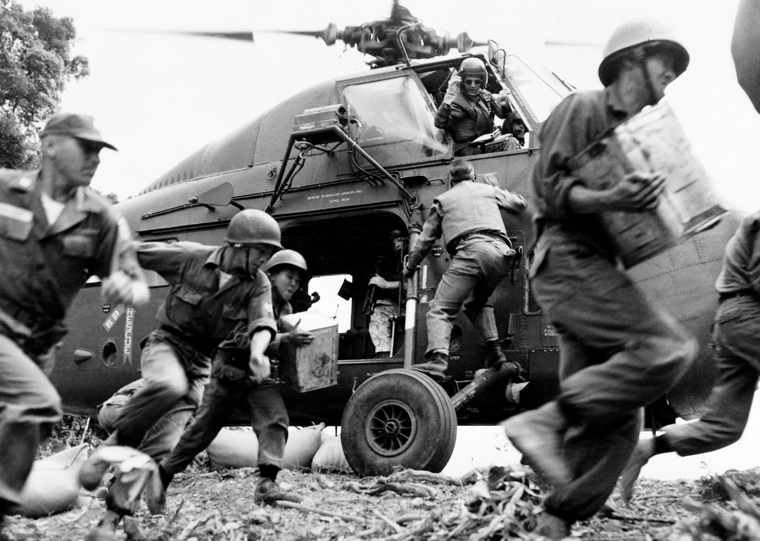Soldiers unloading supplies from US helicopter in Vietnam.