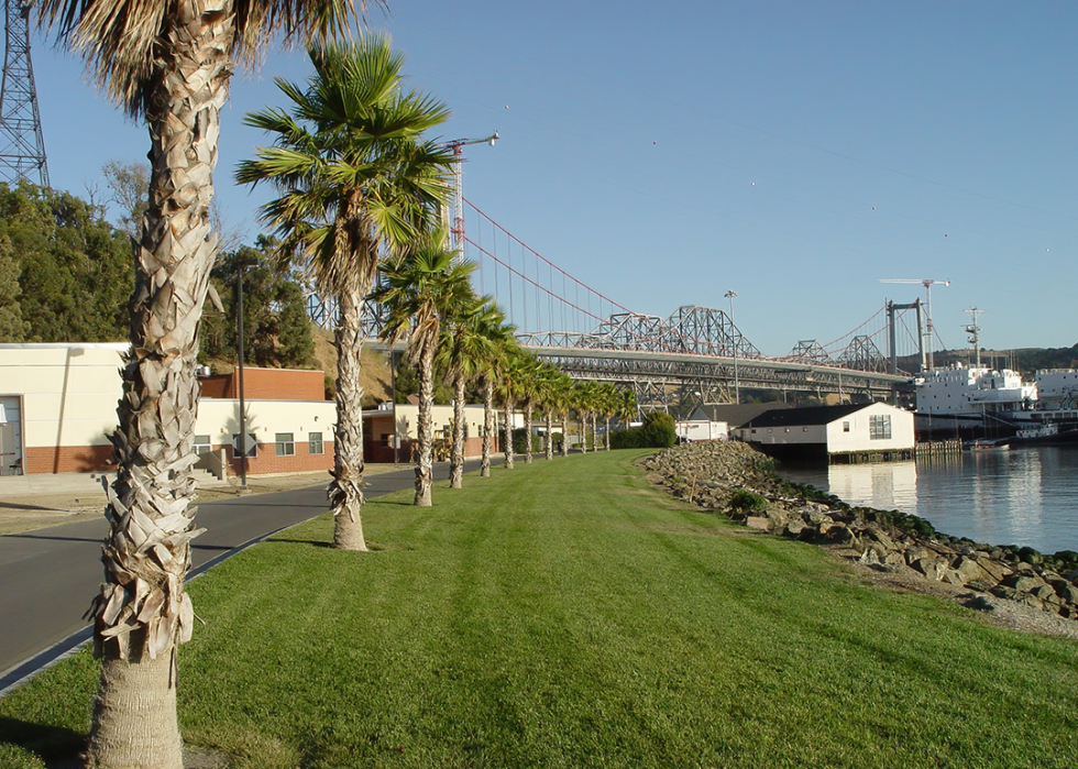 California Maritime Academy Campus with palm trees, bridge and training boat.