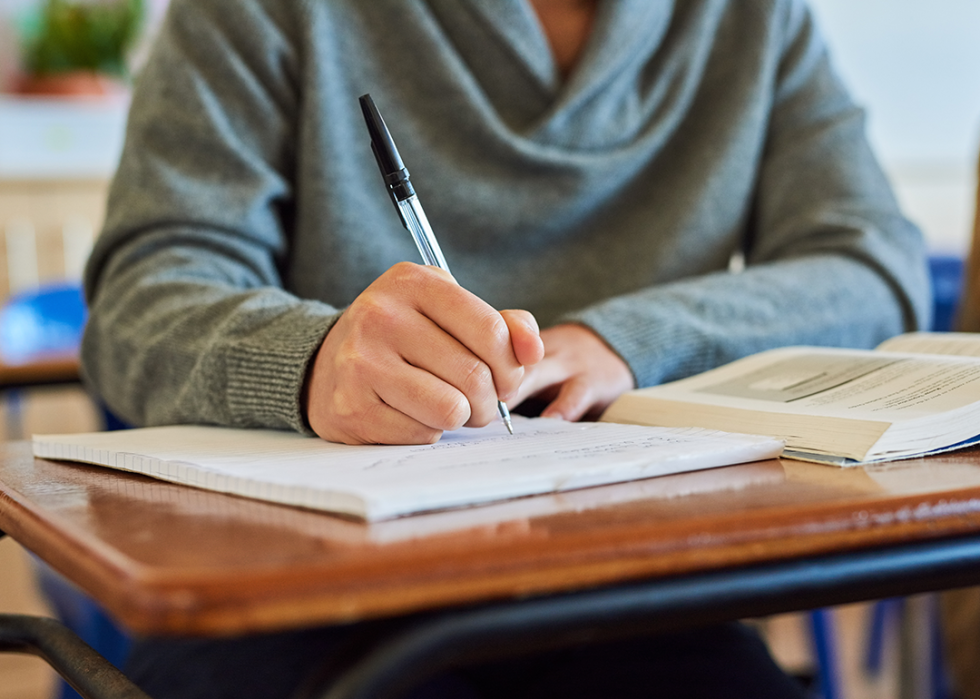 Student writing in notebook.