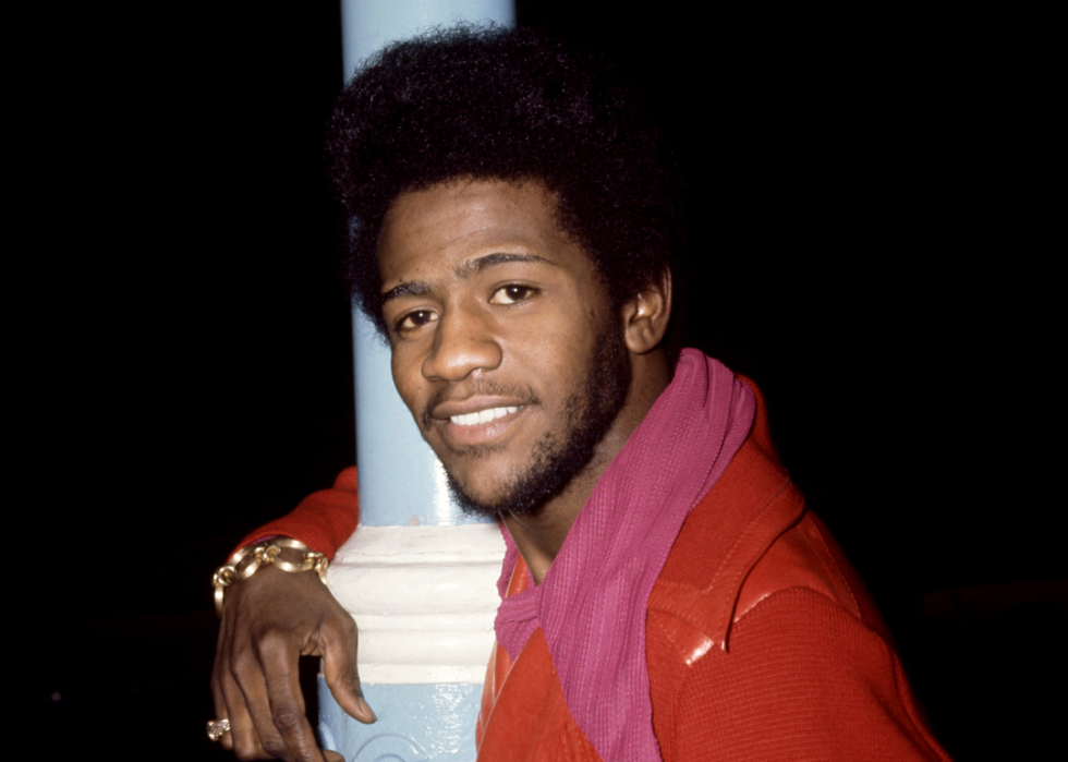 American singer Al Green poses for a portrait wearing red jacket while hugging a lamp post in London in 1971.