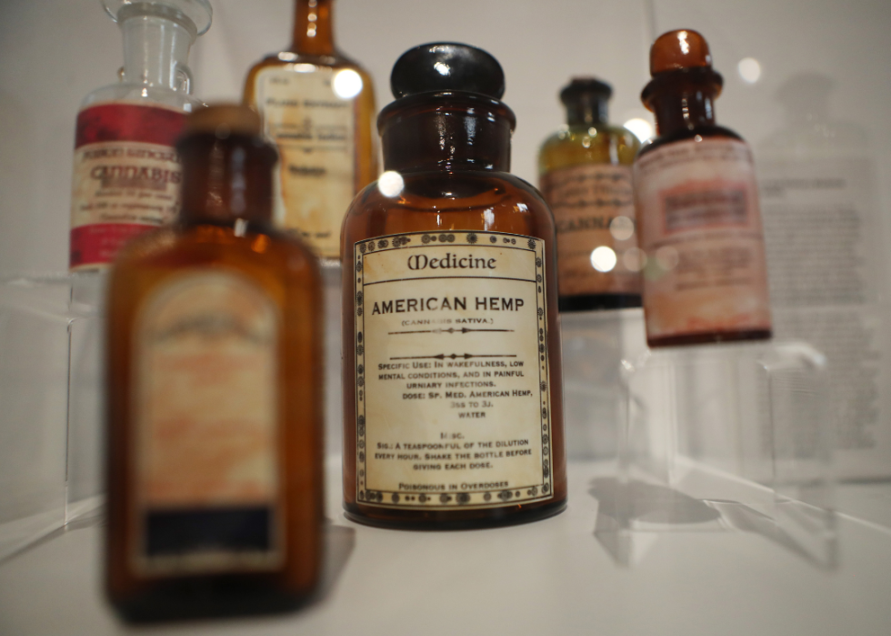 A historic American Hemp medicine bottle is displayed in a museum.