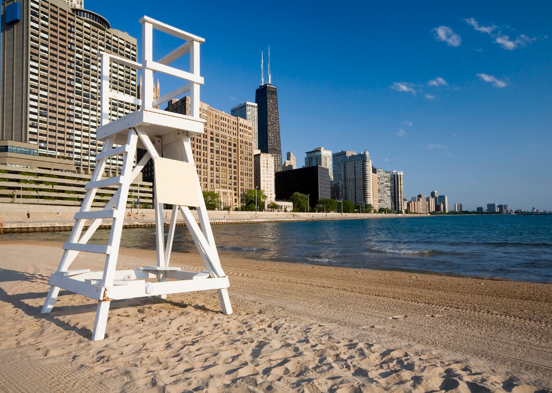 A lifeguard stand on a beach with the Chicago skyline in the background.