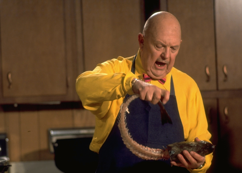 James Beard holding a fish head.