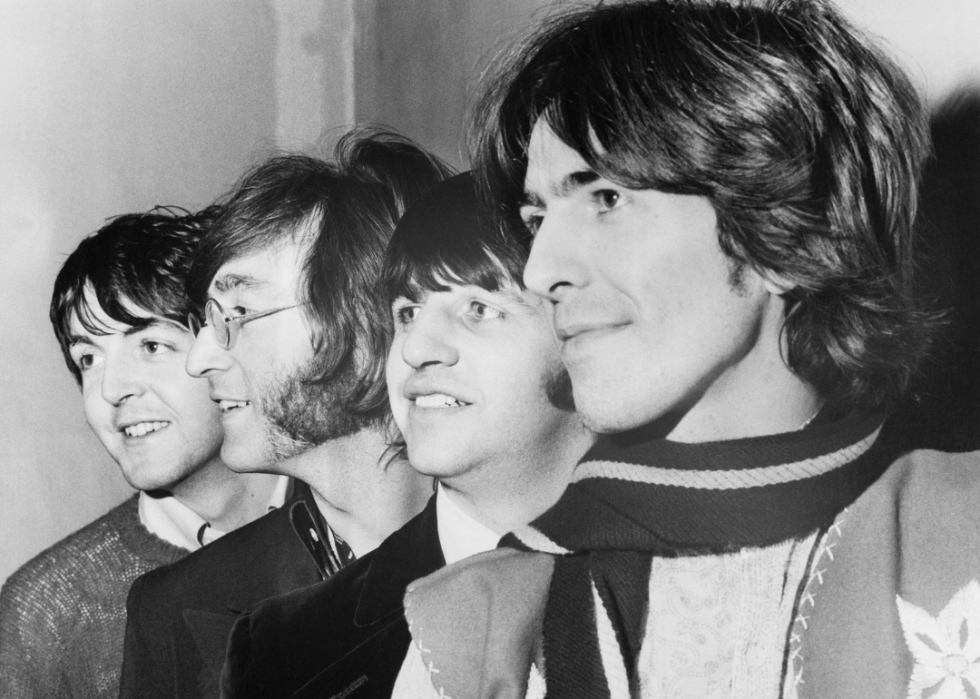 The Beatles lined up in profile.