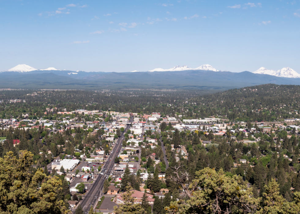 Aerial view of a city with mountains in the background. 