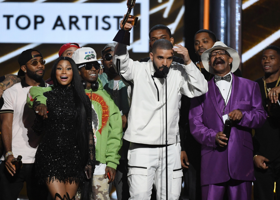 Drake holding award onstage.